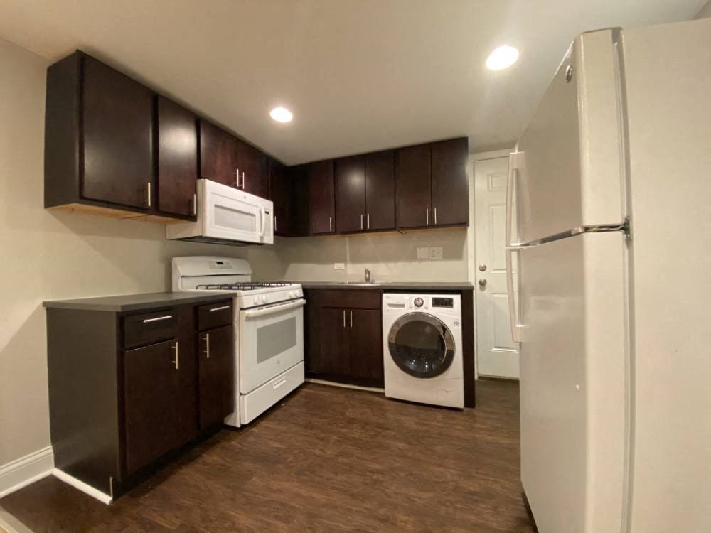 Open kitchen with rich wood cabinets