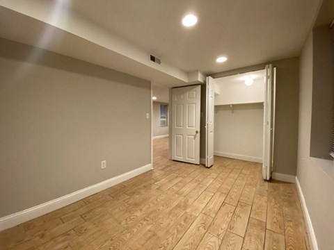 the living room and dining room of a new home with wood floors and grey walls