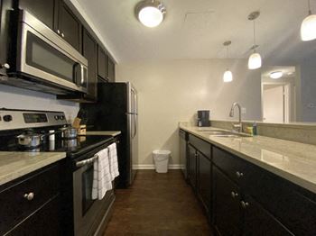 a kitchen with a stove and a sink and a microwave