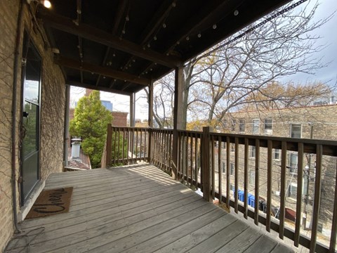 the deck has a view of the street and a building in the distance