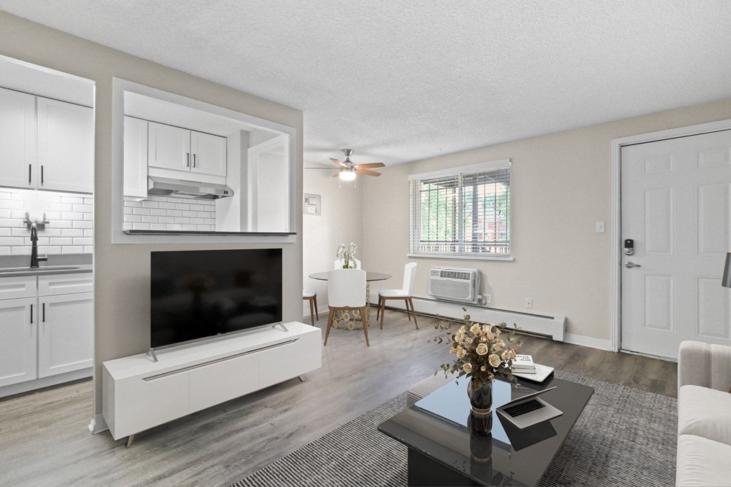 an open living room with a tv and a dining room