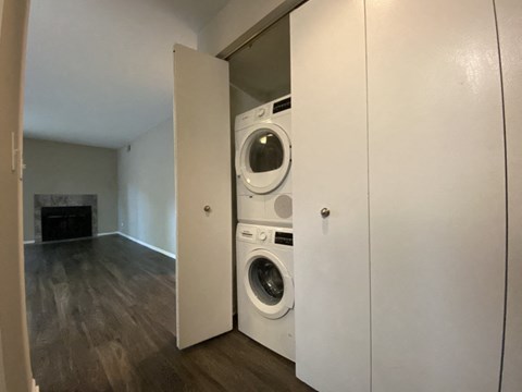 a washer and dryer in a closet in a living room