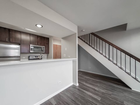 a kitchen with a counter and a staircase in a house