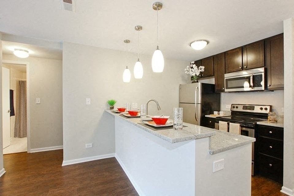 Kitchen with stainless steel appliances and a breakfast bar
