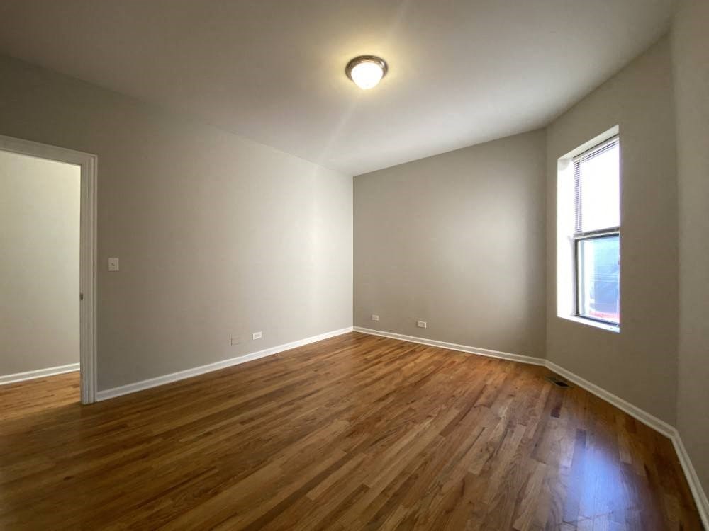 Large bedroom with rich wood flooring - 3 Bedroom 2 Bath