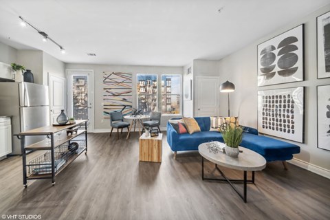 A modern living room with a blue couch and a coffee table.