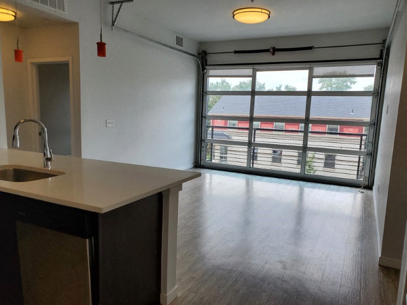 Unique garage door offering abundant natural light at Wash Park Station in Denver, CO