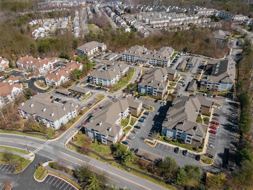 A bird's eye view of a residential area with houses and roads.