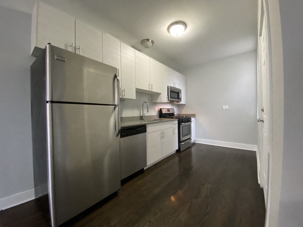 Kitchen with nice white cabinets and a built-in microwave - 2 Bedroom