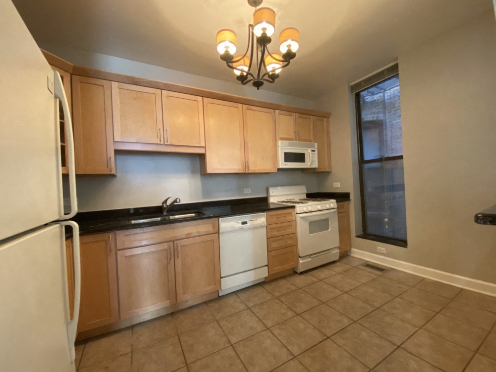 Kitchen featuring granite countertops, dishwasher and gas range