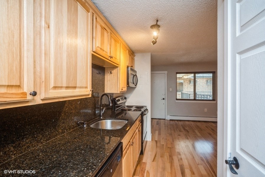 Spacious kitchen with views to the living room area at 23–33 Pearl St in Denver, CO