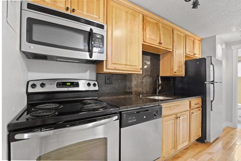 a kitchen with stainless steel appliances and wooden cabinets