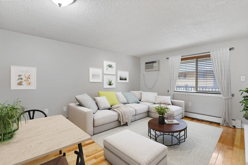 A living room with a white couch and a coffee table at 23–33 Pearl St in Denver, CO