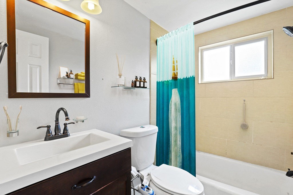 A bathroom with a white toilet and a sink at 23–33 Pearl St in Denver, CO