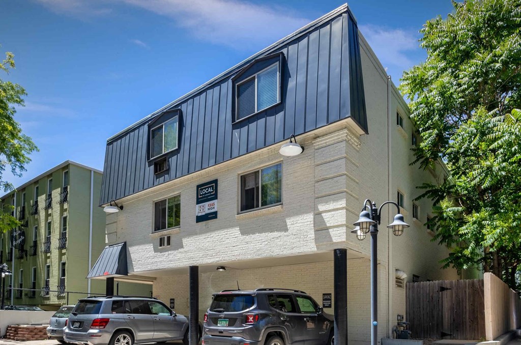 a building with two cars parked in front of it