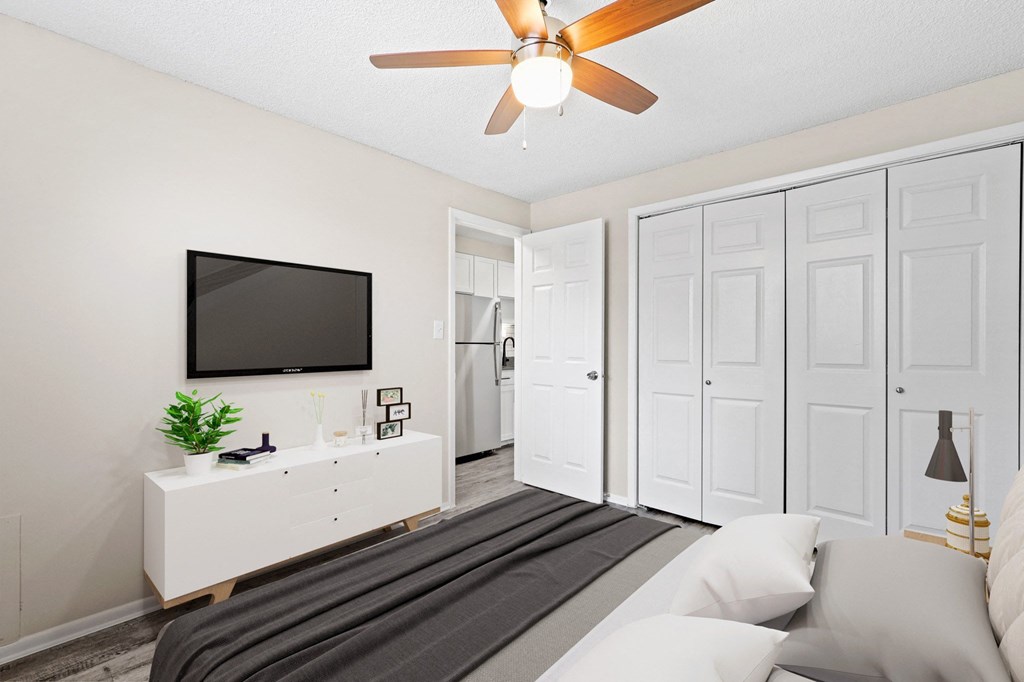 a bedroom with a bed and a ceiling fan