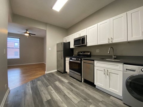 a kitchen with stainless steel appliances and white cabinets
