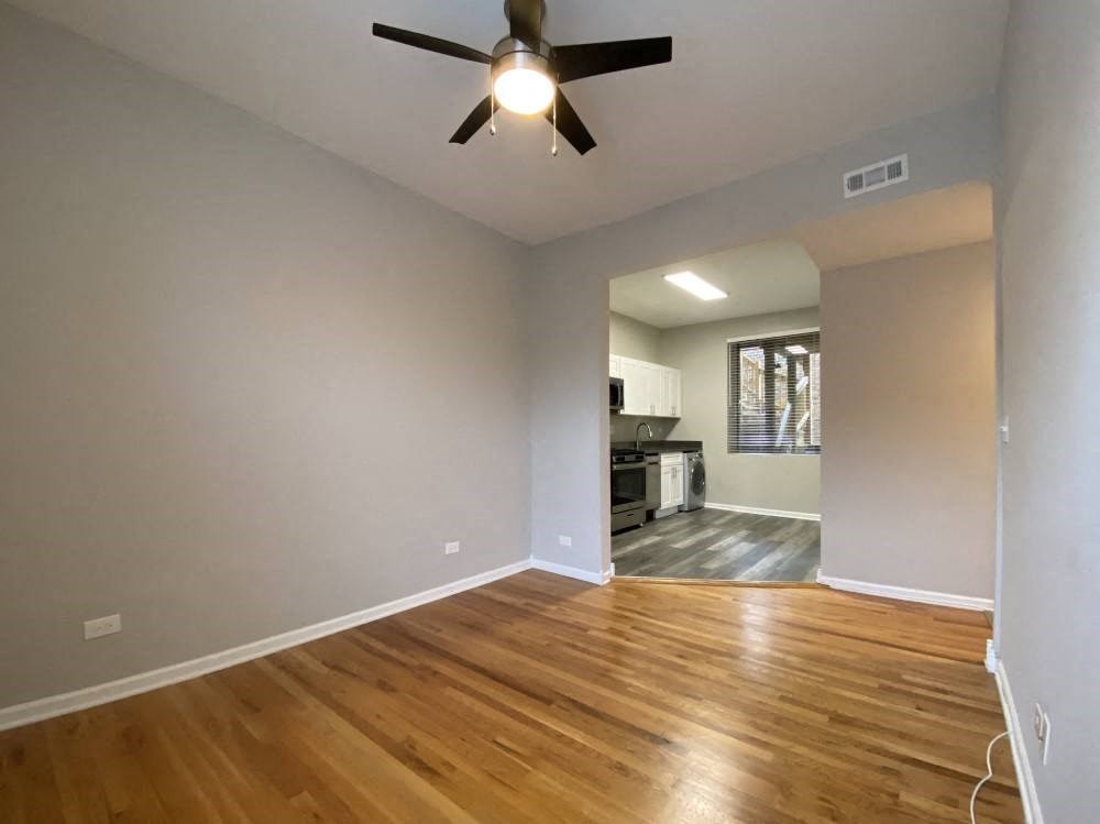 Living room with hardwood flooring and a ceiling fan