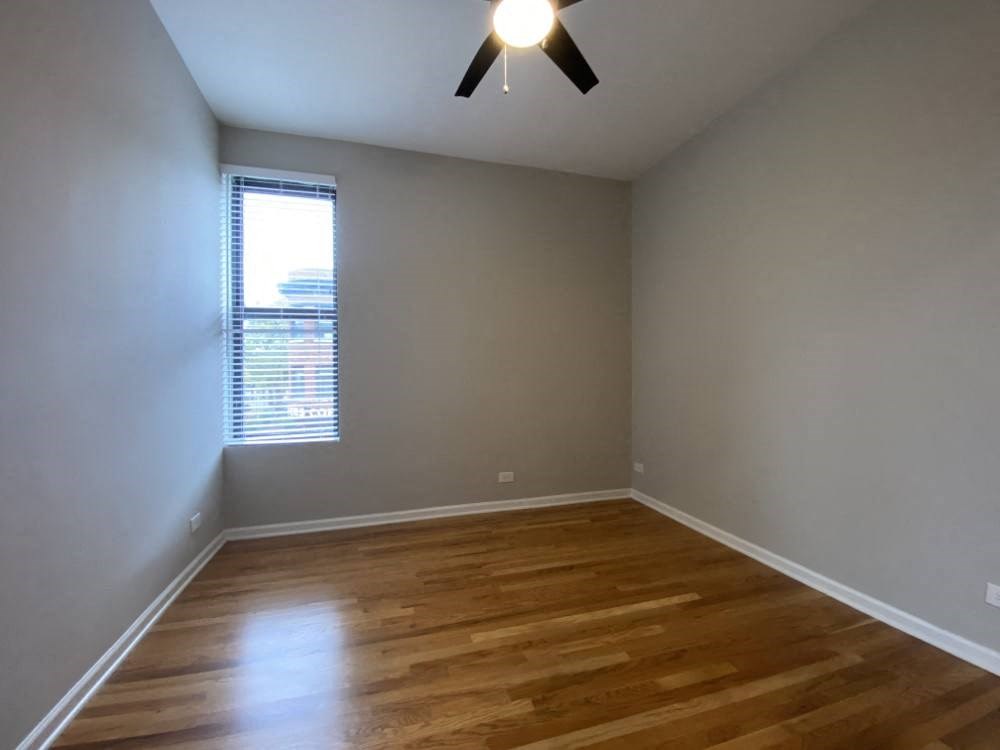 Bedroom with a window and a ceiling fan