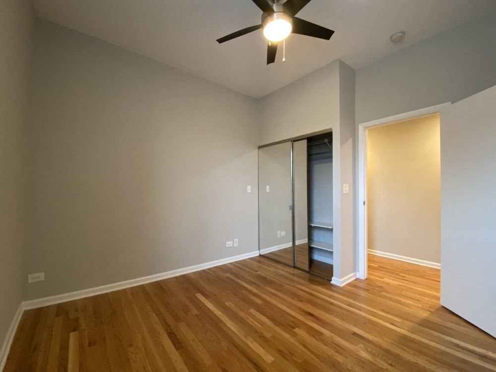 Bedroom with a closet and hardwood flooring
