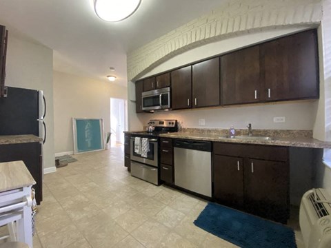 a kitchen with an island and a stove and a microwave
