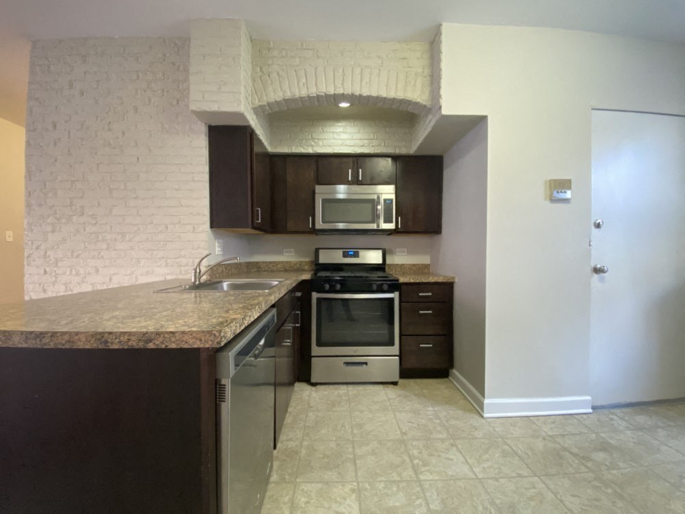 Kitchen with stainless steel appliances and a built-in microwave - 2 Bedroom B