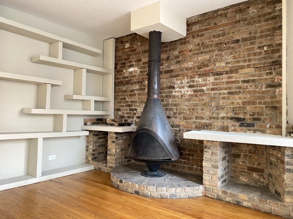Fireplace and a wall of built-in shelves in the living room - 2 Bedroom B