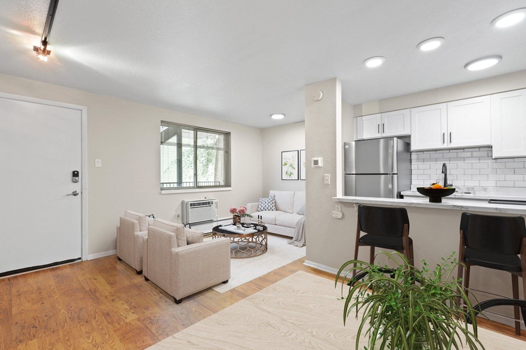 an open living room with a kitchen and a living room