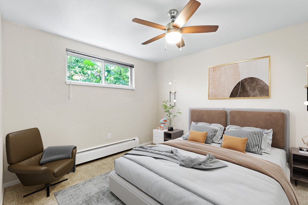 a bedroom with a large bed and a ceiling fan