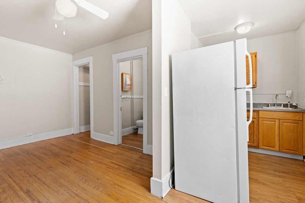 a room with a refrigerator and a bathroom in it