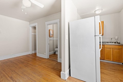 Open and airy with hardwood floors and a compact kitchen setup 1170 N Logan St in Denver, CO