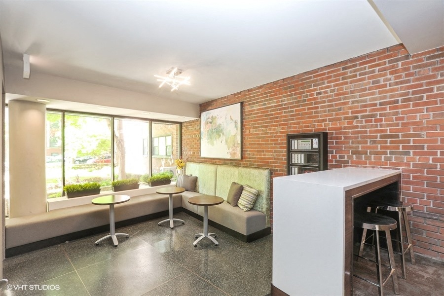 Lobby with exposed brick and comfortable seating areas  at 5550 S Dorchester, Chicago, 60637