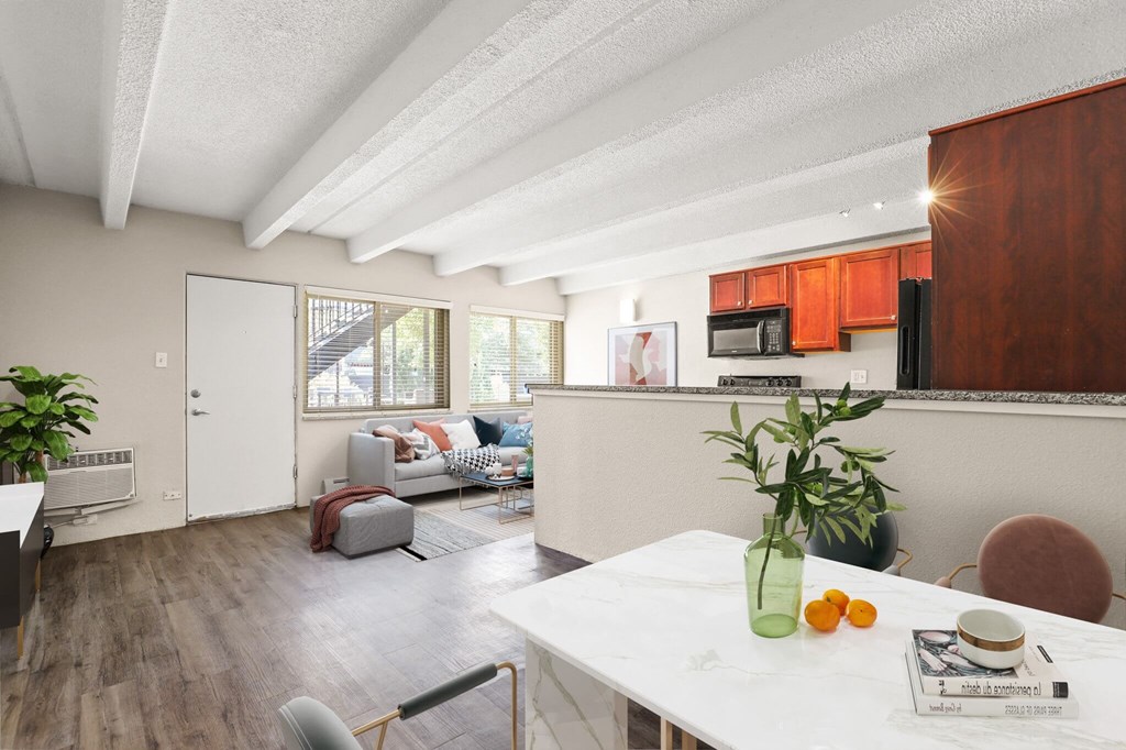 a kitchen and living room with a white counter top