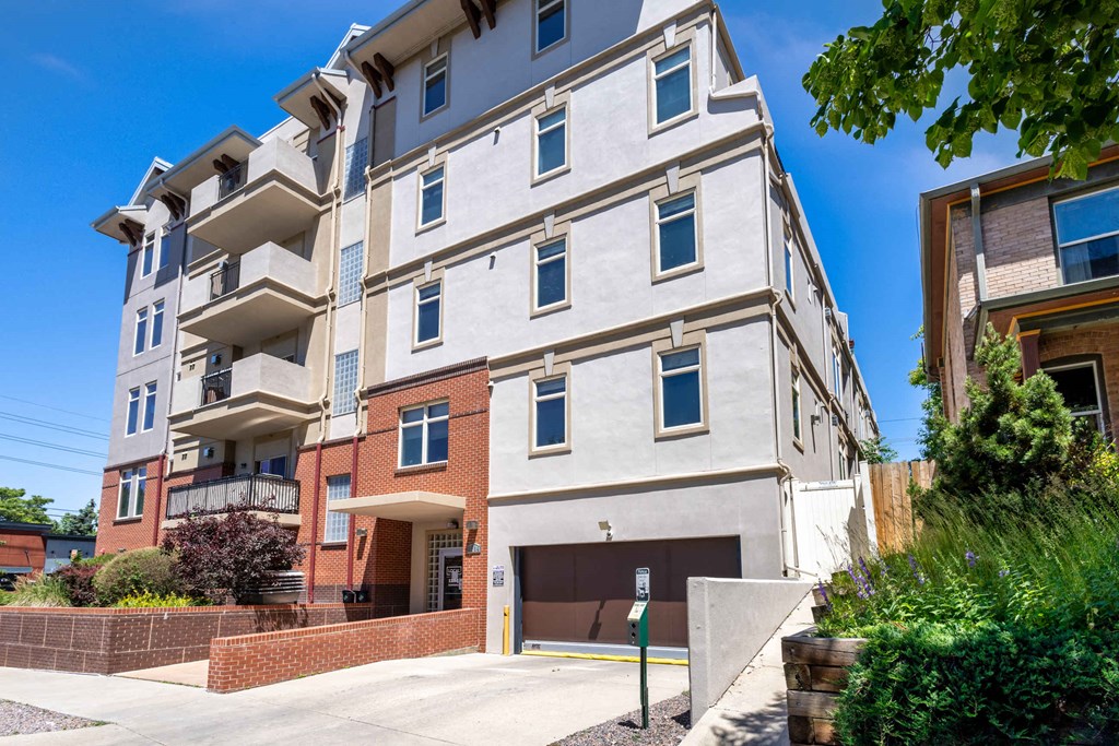 an apartment building with a driveway and a parking garage