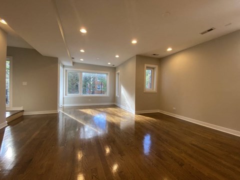 a living room with a hard wood floor and a window