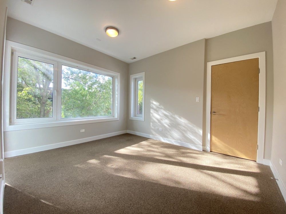 Bright bedroom with large windows