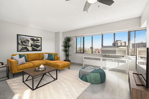 A living room with a yellow couch and a coffee table.