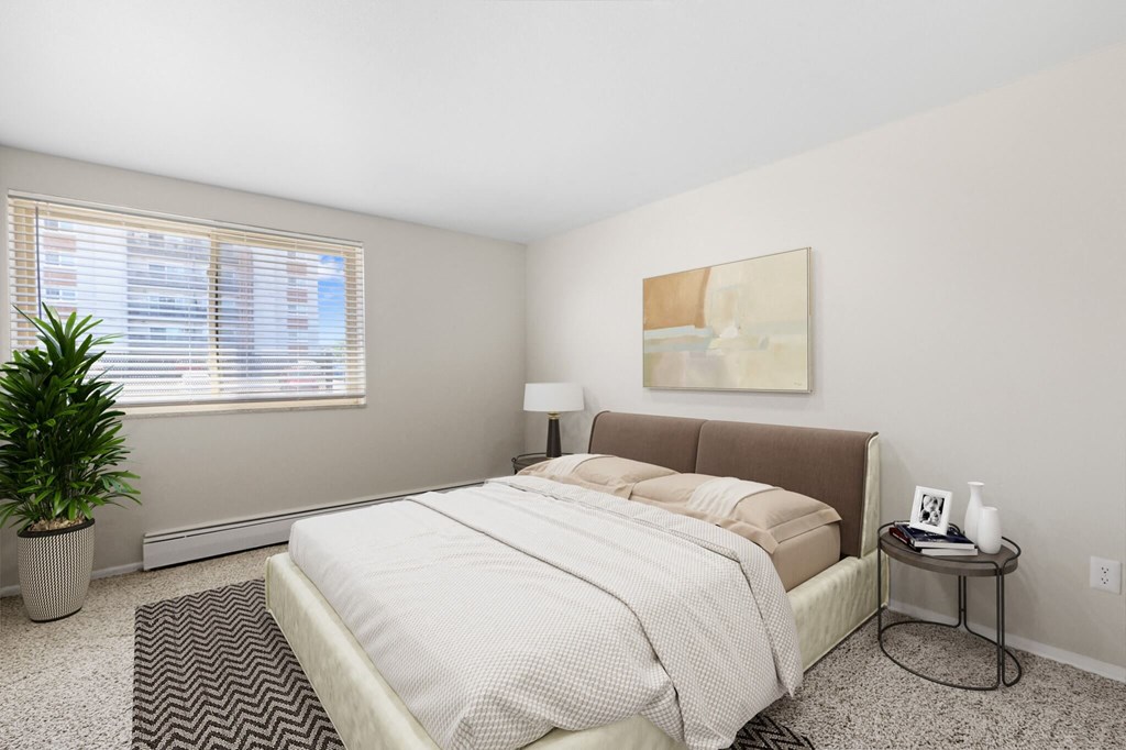 a bedroom with a bed and a large window