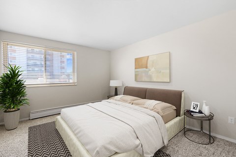 A peaceful retreat with plush carpeting, neutral tones, and city views at 1190 S Bellaire St in Denver, CO