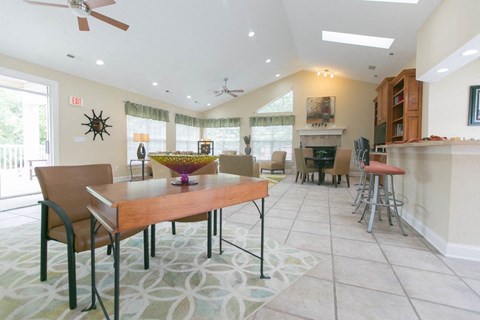 A dining room with a table and chairs.