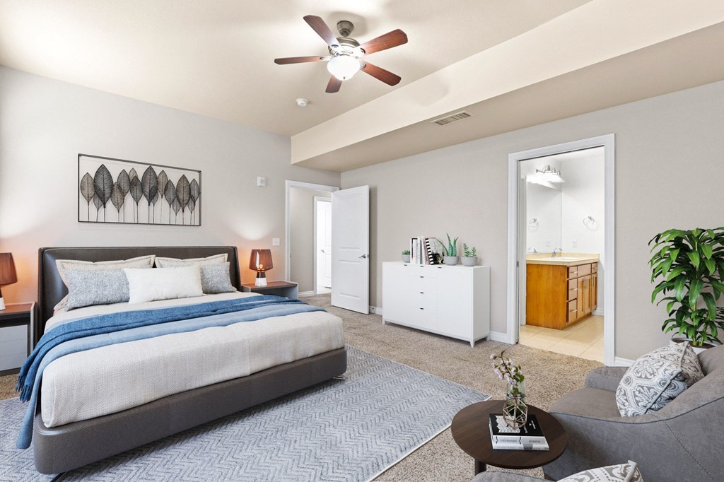 a bedroom with a bed and a ceiling fan
