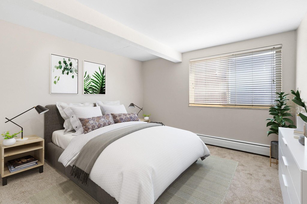 a bedroom with a large bed and a window