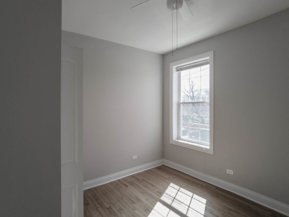 Bedroom three with high ceilings and great city views
