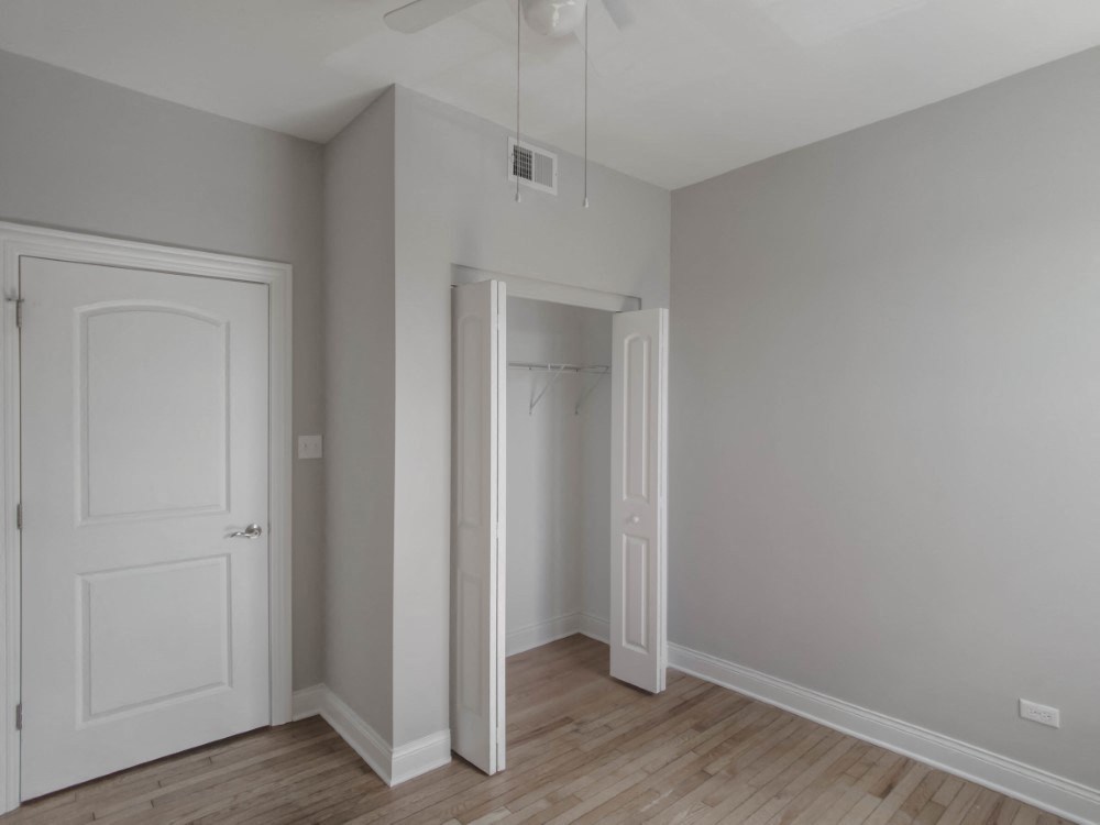 Bedroom three with closet space and a ceiling fan