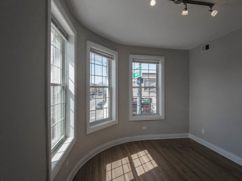 Living room with rich wood flooring and gorgeous city views