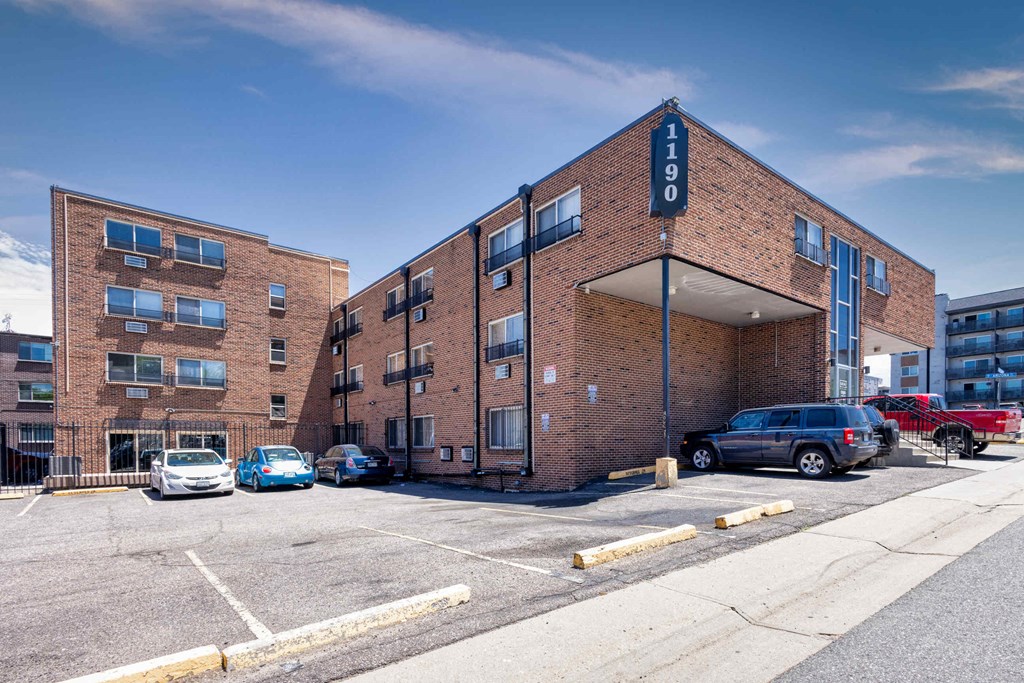 a large brick building with cars parked in front of it