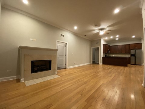 a living room with a fireplace and a wooden floor