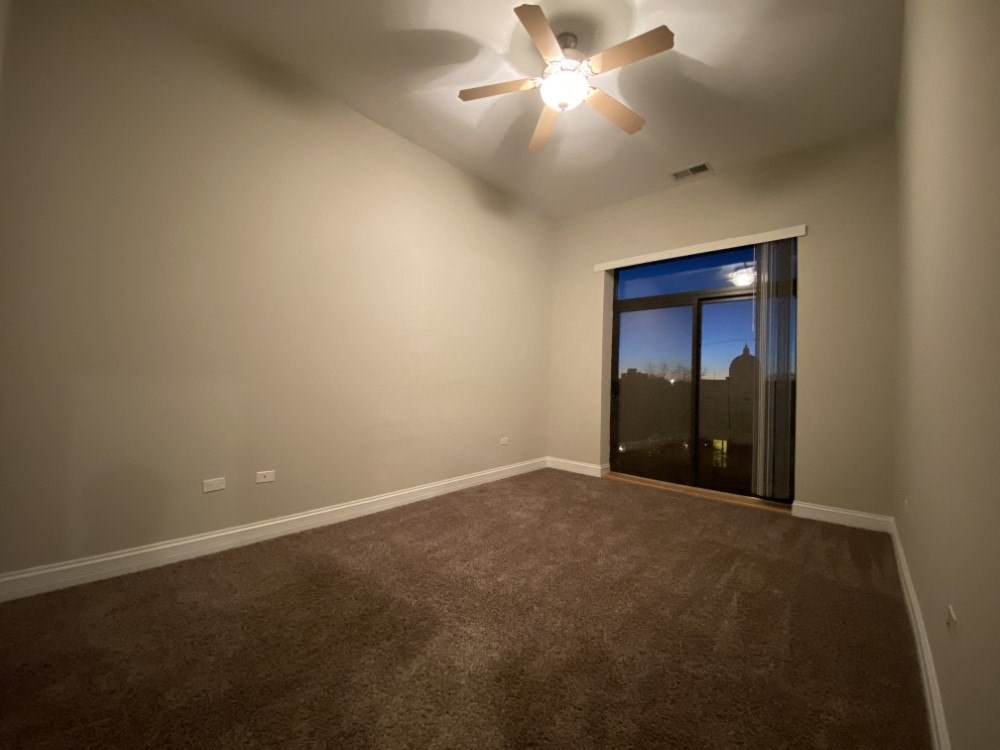 Bedroom with plush carpeting and private patio access - 3 Bedroom
