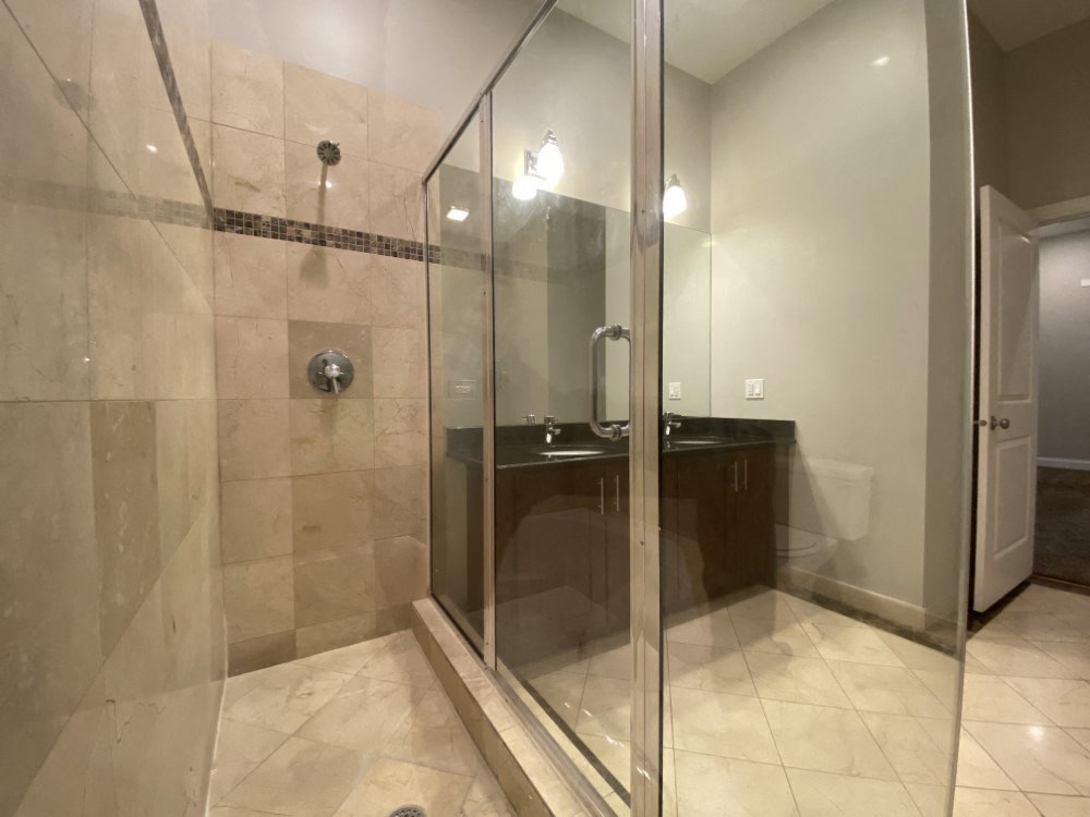 Shower with glass enclosure and tiled walls - 3 Bedroom