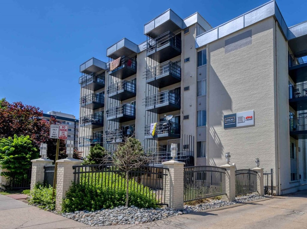 A modern apartment building with balconies and a gated entrance  at 4805 E Kentucky in Denver, CO